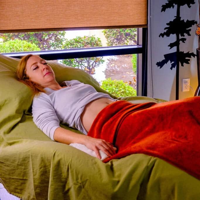 Patient relaxing during an acupuncture therapy appointment