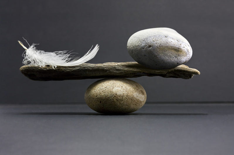 balancing a rock and feather