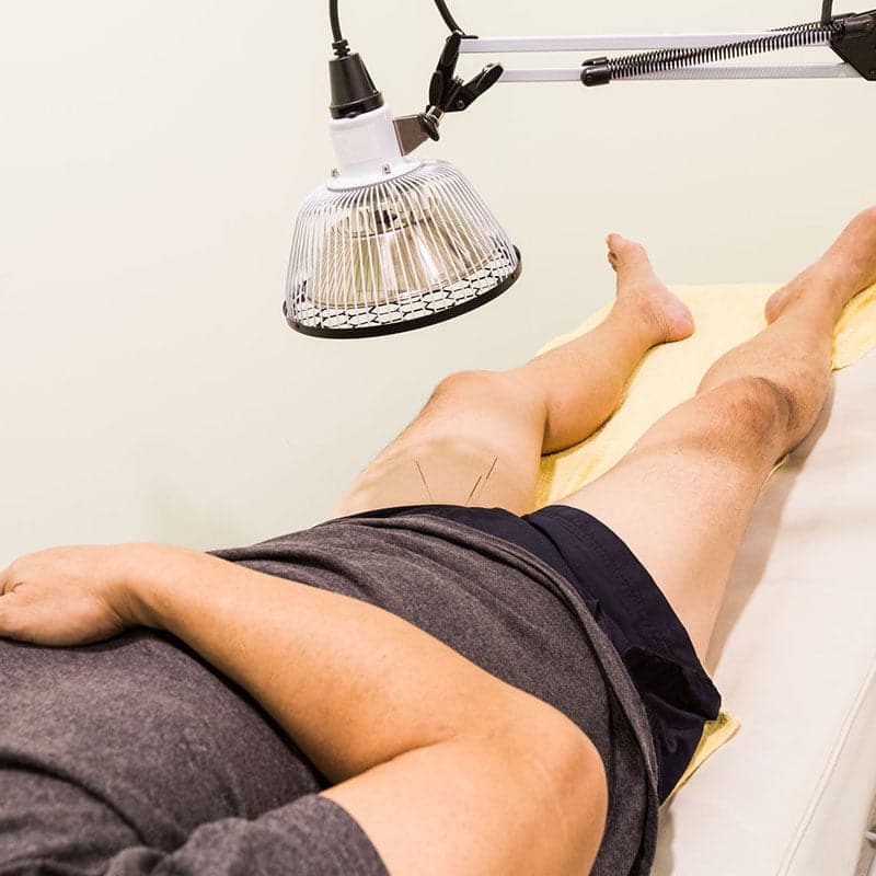 Man on office table during moxibustion therapy