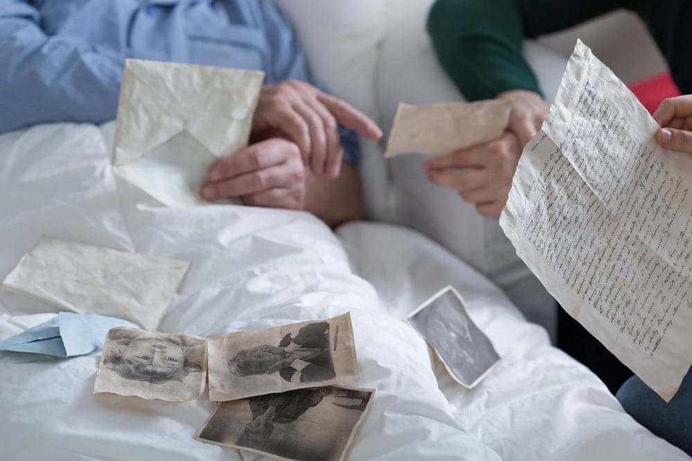 visitor sitting with patient while going through photos