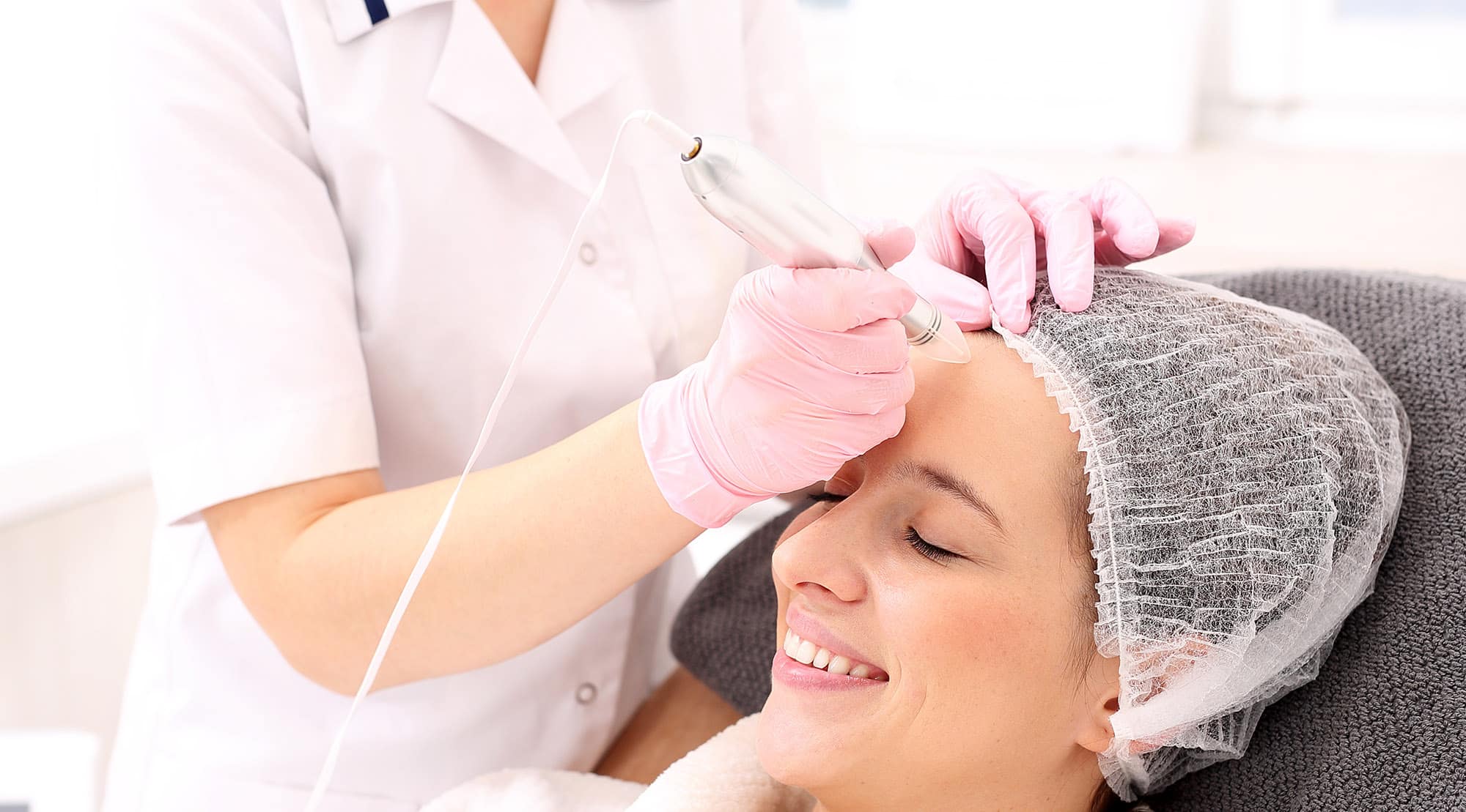 Erin performing a microneedle treatment on patient