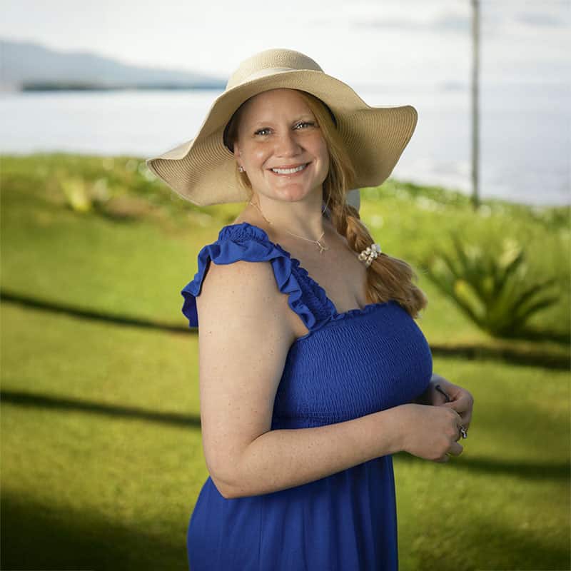 Dr. Erin West in blue sundress on Maui beach